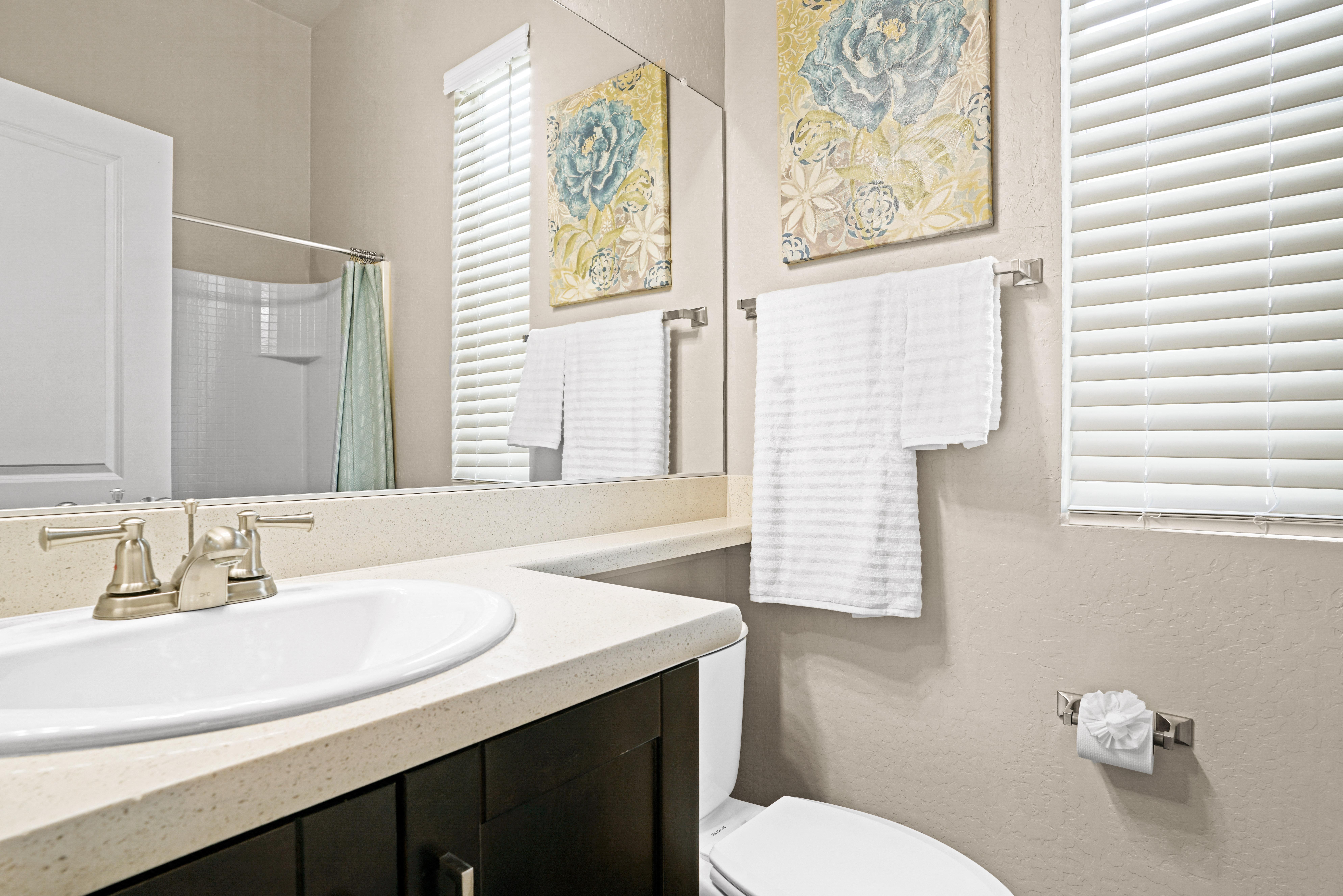 a bathroom with a sink and a mirror and a toilet at Olive Queen Creek Apartments, Arizona, 85142